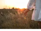 woman outside in field to represent being free from trauma